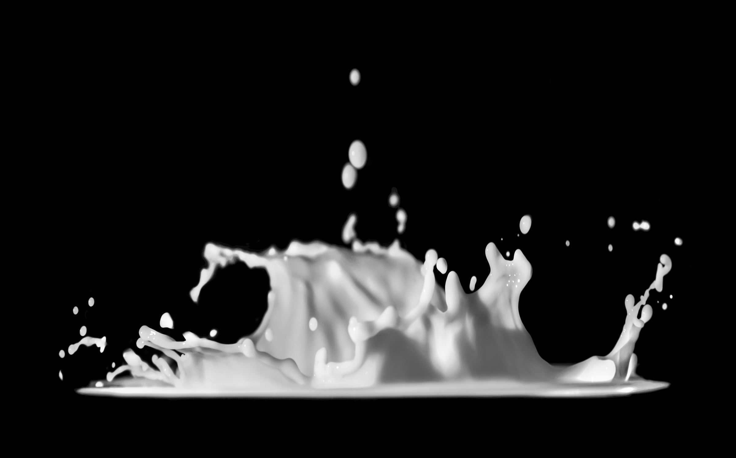 Fresh cold milk splashing on a surface