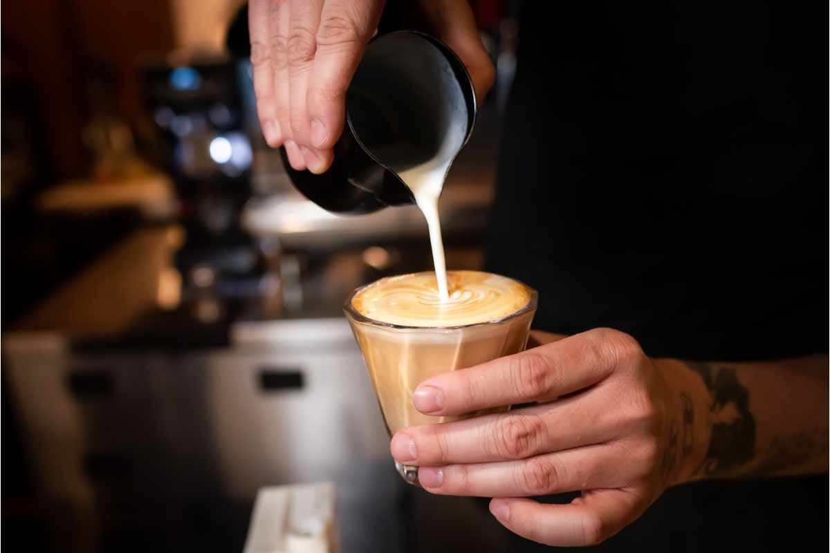 bartender while pouring a flat white