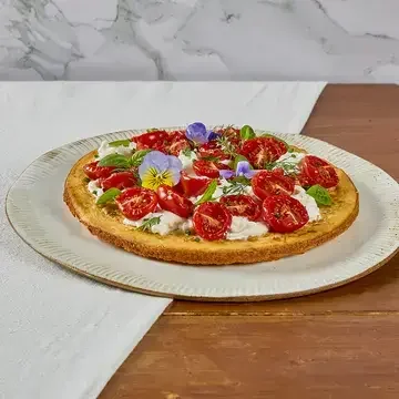 Crispy socca with stracciatella, confit tomatoes and Mediterranean herbs