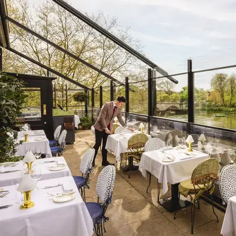 A waiter setting the table on the terrace at Scott's Richmond.
