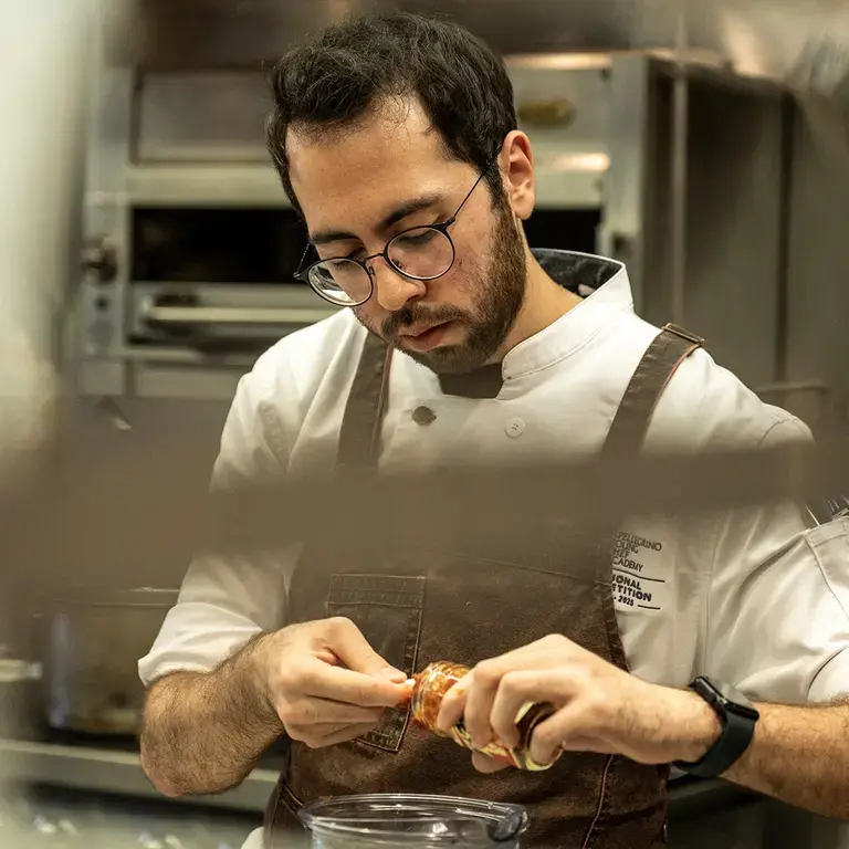 Nicolás A. López in the kitchen at the SPYCA Competition Regional Final.