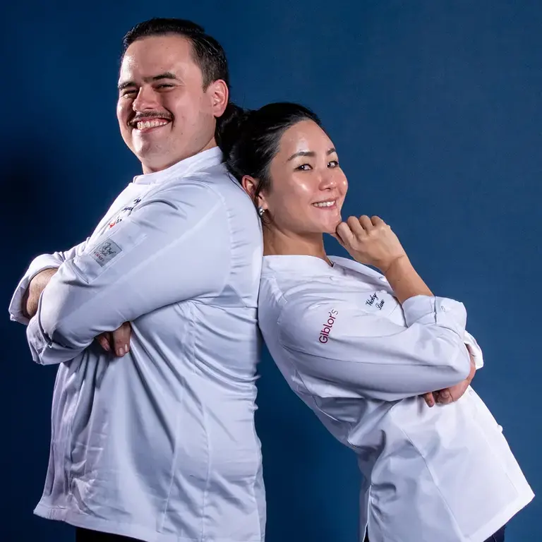 Ardy Ferguson and Vicky Lau standing back to back.