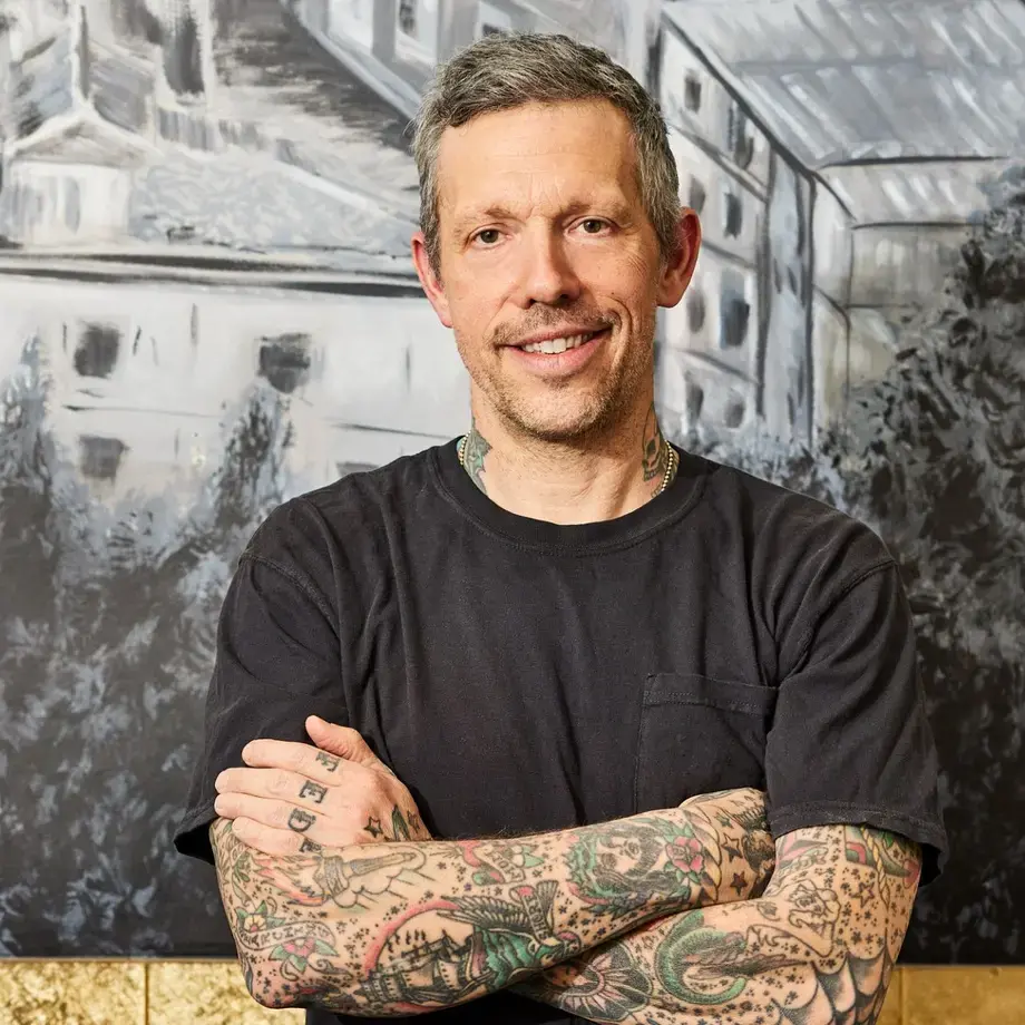 a portrait image of Anthony Mangieri crossing his arms