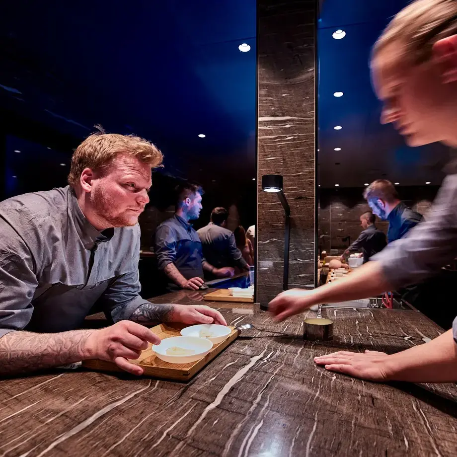Head Chef Rasmus Munk plating the impression King Crab together with chef Rasmus Bermann.