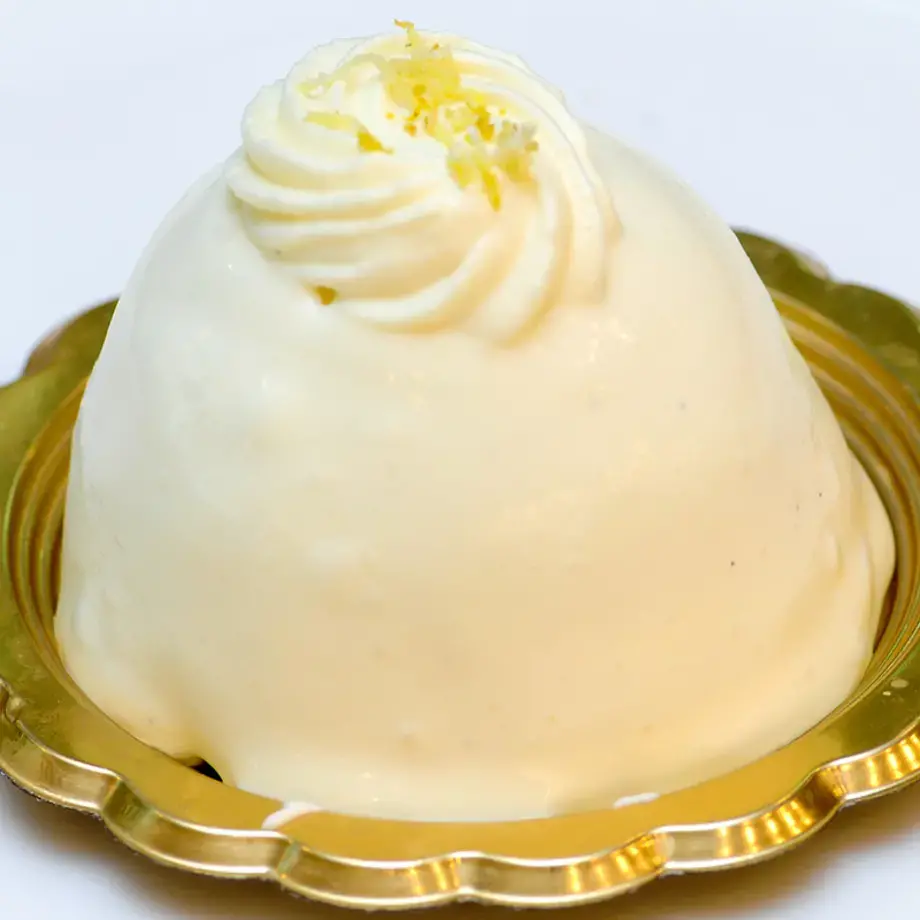 A lemon delight dessert on a gold dish.