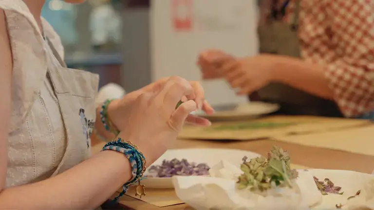 Creative plating of summer tomatoes with basil and edible flowers