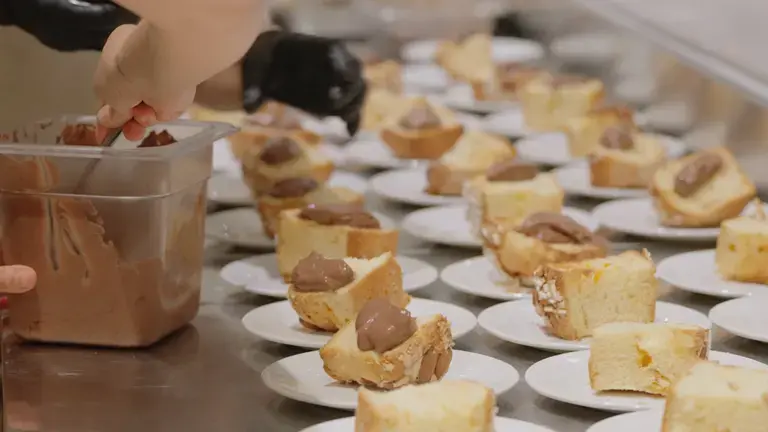 Slices of panettone served with chocolate cream in a professional pastry setting