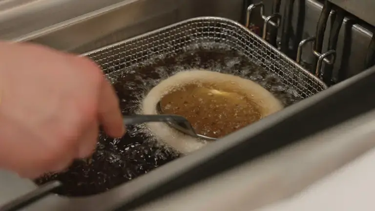 Fried pizza cooking in hot oil