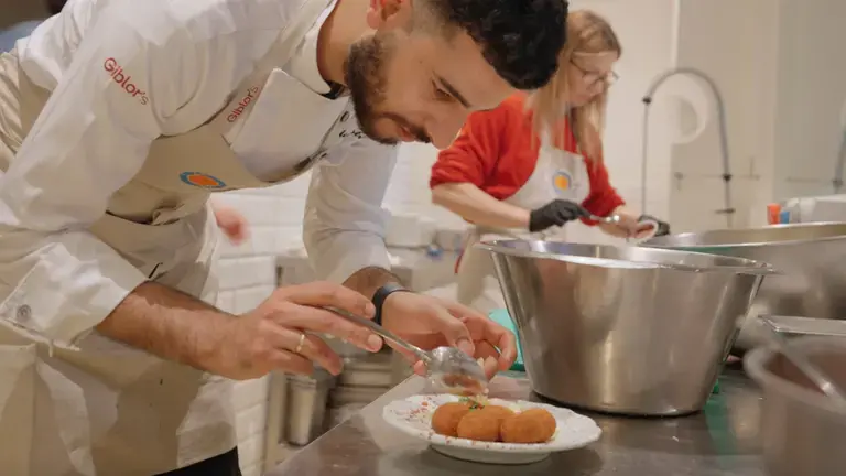 The chef plating the meatballs