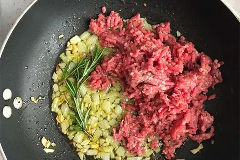 ground beef browning in the pan