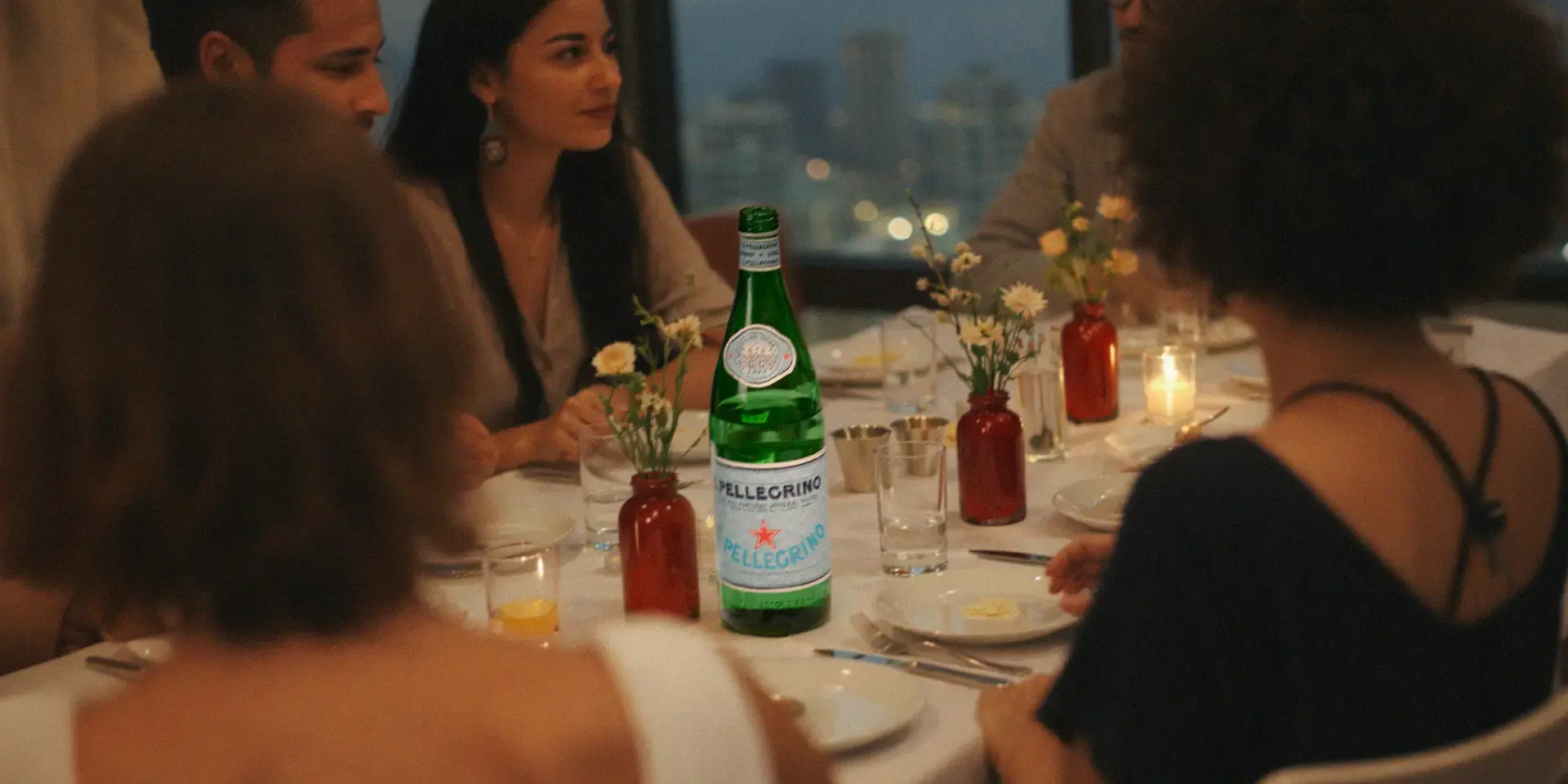 people dining together with S.Pellegrino water bottle