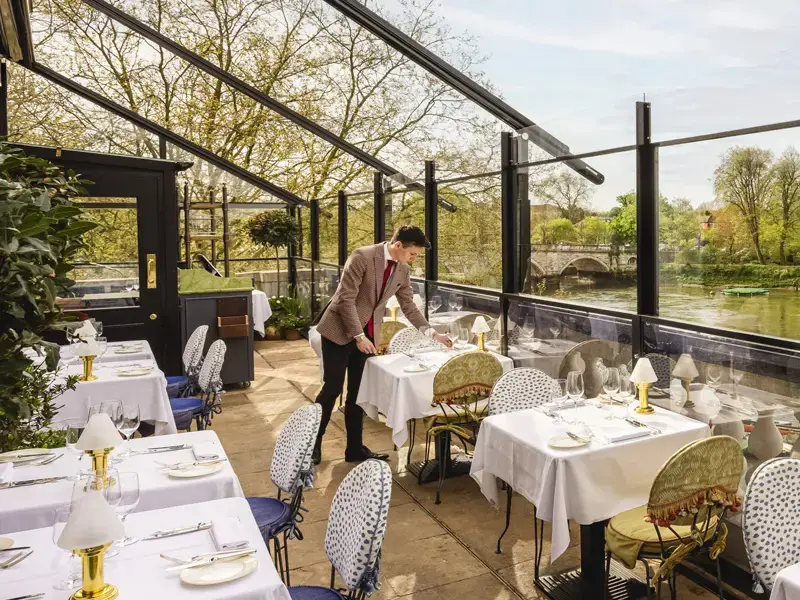 A waiter setting the table on the terrace at Scott's Richmond.