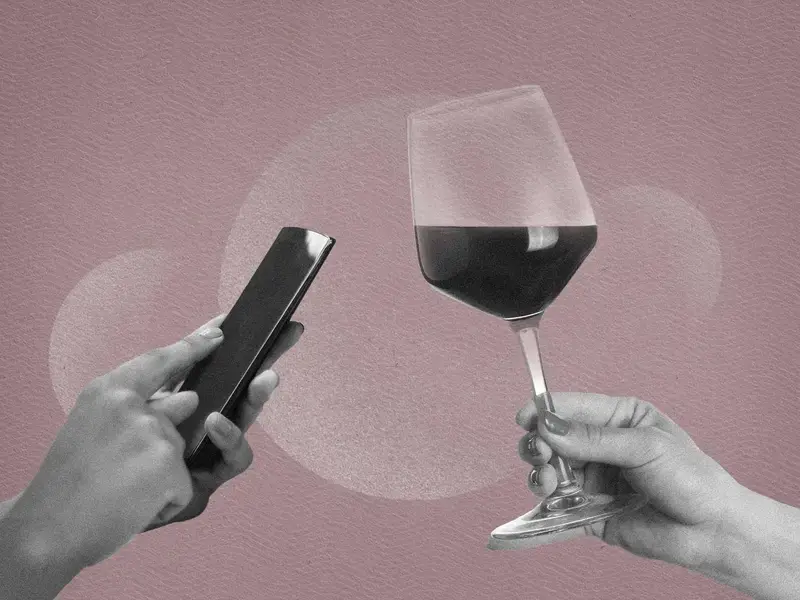 A mobile phone and wine glass.