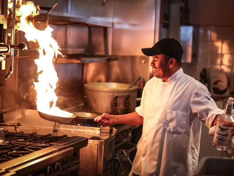 chef with pan on fire