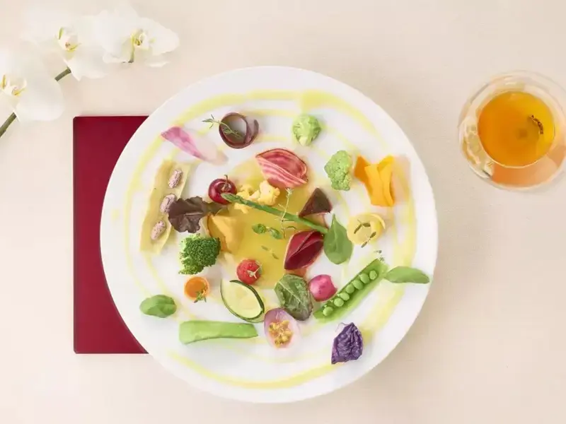 a colourful fine dining dish against a white background