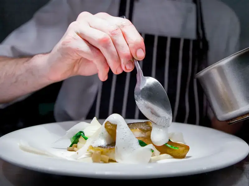 Close up on a young chef hand cooking